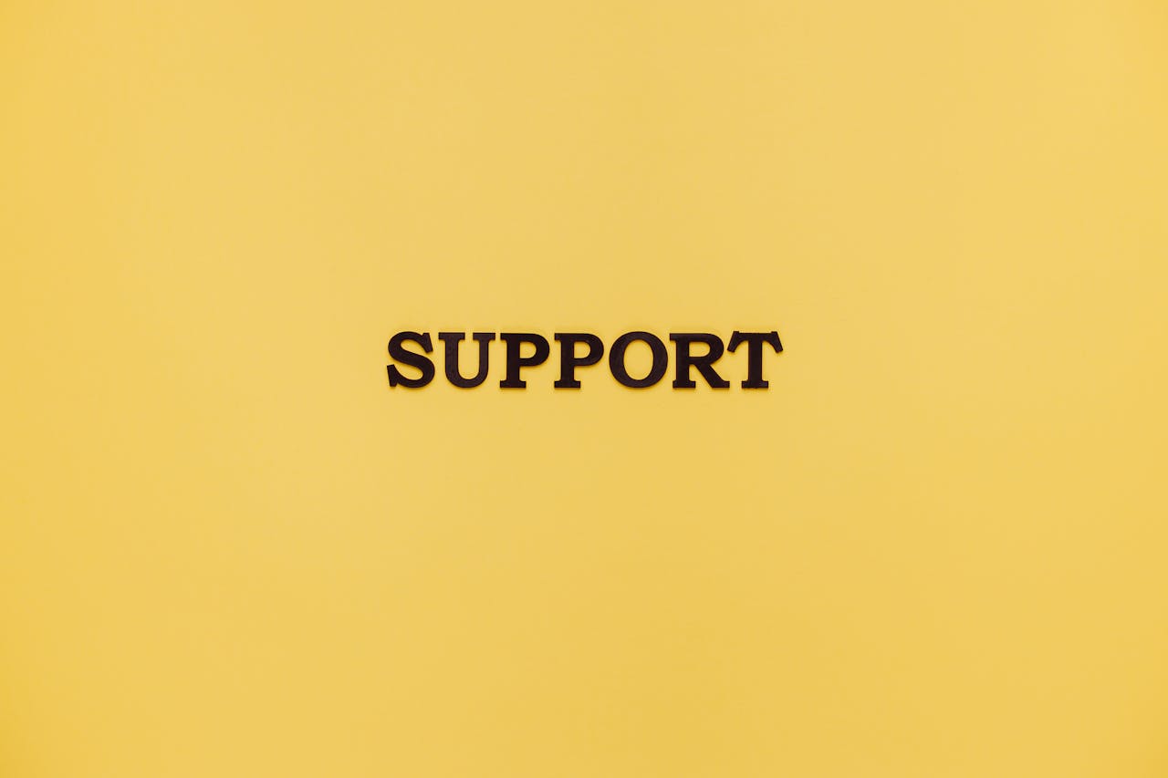 Minimalist image with 'Support' text on a yellow background for conceptual themes.